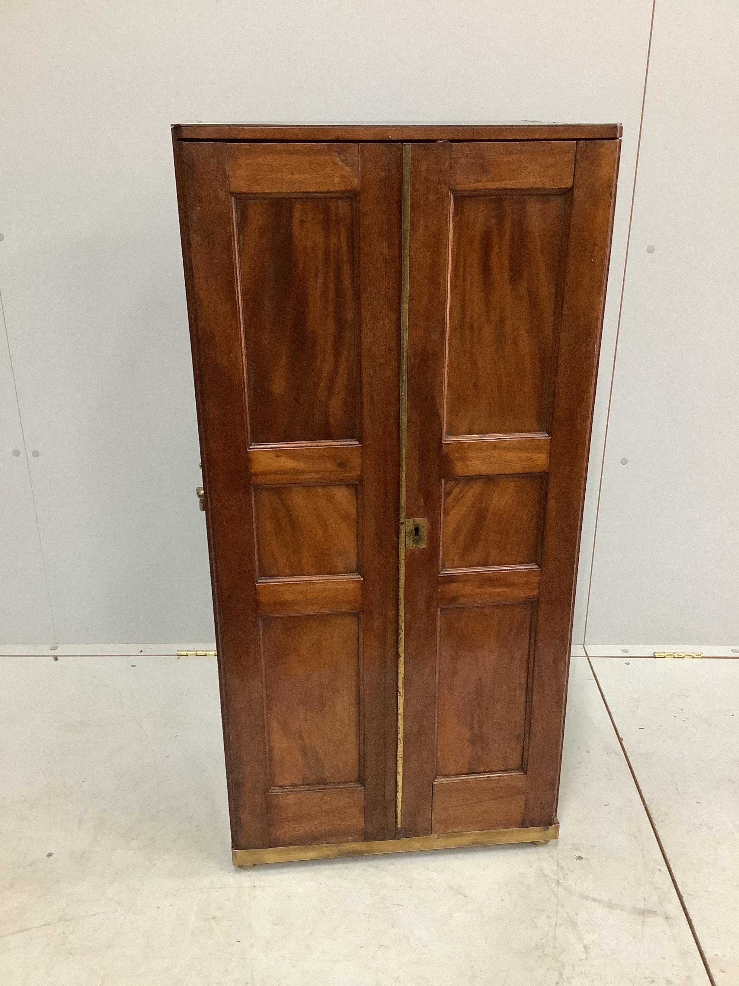 A 19th century brass mounted mahogany pigeonhole cabinet with tapered right side, possibly from a ship, width 53cm, depth 34cm, height 112cm